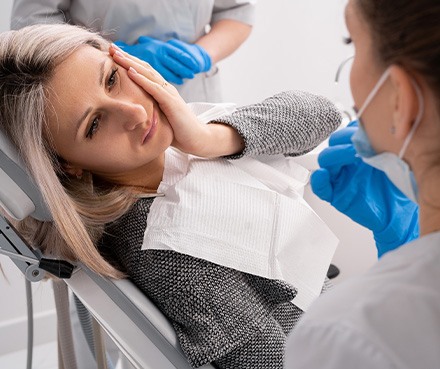 An unhappy woman waiting to have her toothache treated