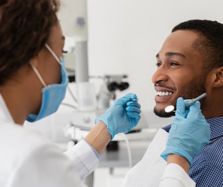 a patient smiling during a dental checkup