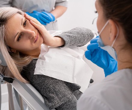 Lady in dentist’s chair has oral pain