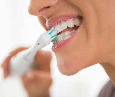 a person brushing their teeth at home