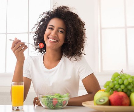 a woman enjoying a bowl of healthy food