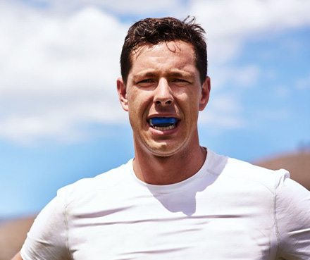 a man wearing blue custom mouthguards