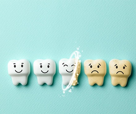 A row of animated teeth on a teal surface with the white ones happy and the stained ones sad