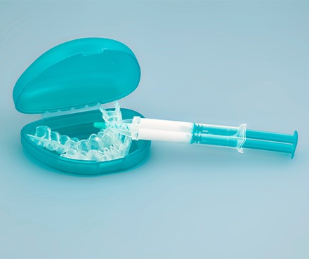 Teal colored teeth whitening applicator tray and gel