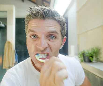 man brushing his teeth